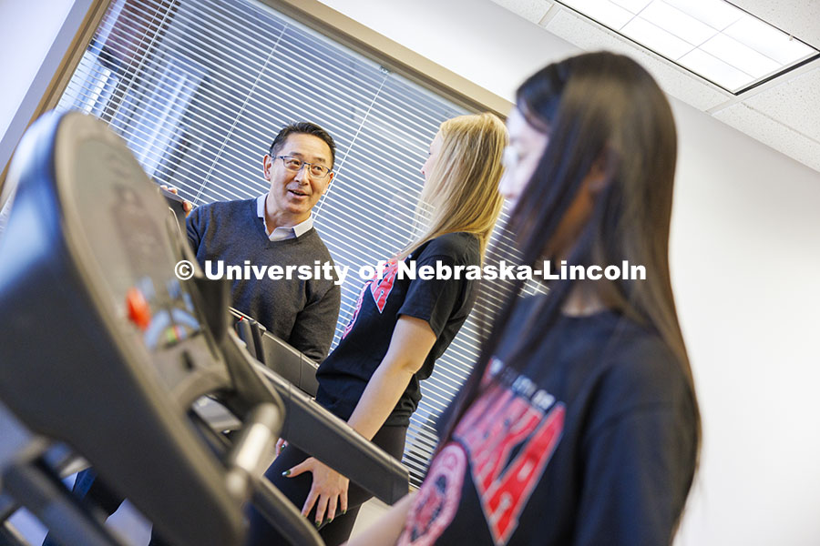 Shinya Takahashi talks with Anna Zingler as she and Lauren Marshall run on treadmills. Takahashi, As