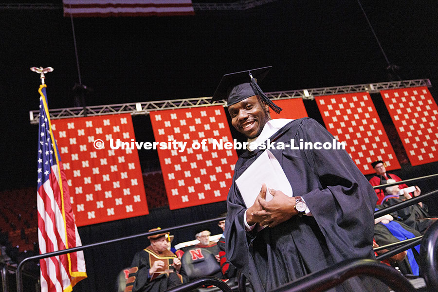 Augustine Ilemirewojor Okorodudu walks off the stage after receiving his master’s degree. Graduate