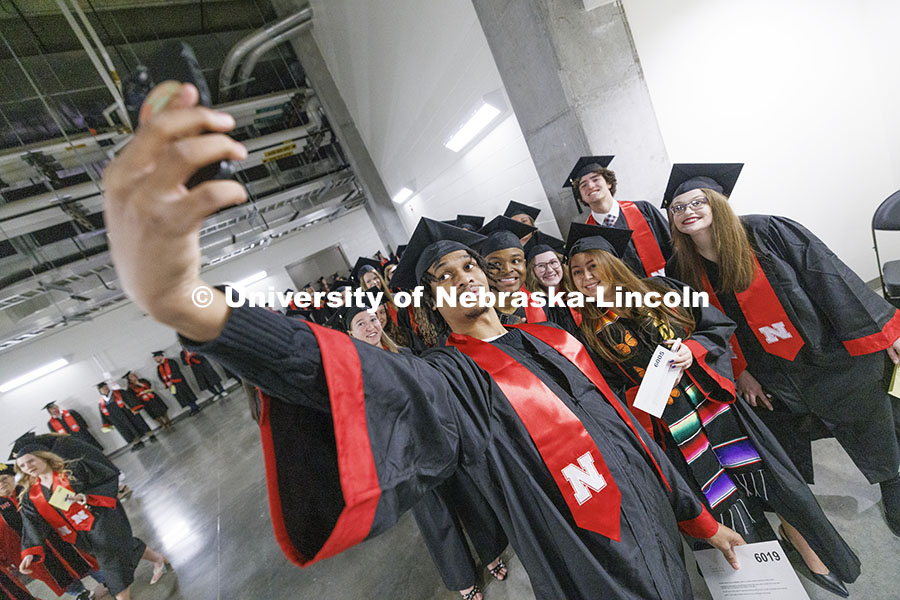 Cameron King takes a selfie of him and his fellow CoJMC graduates before the ceremony. Winter underg