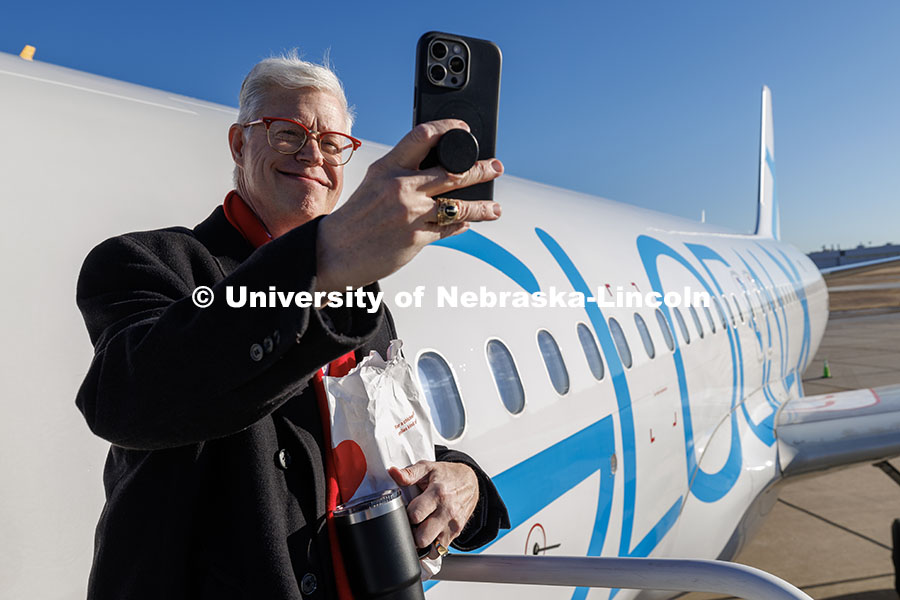 UNL's Peter Ecklund takes a selfie outside of the plane. Inauguration choir trip. January 17, 2025. 