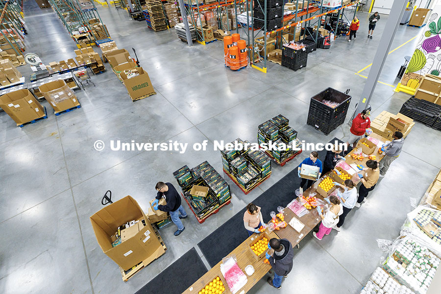 University of Nebraska–Lincoln students place oranges into bags during SLICE’s Engage Lincoln vo