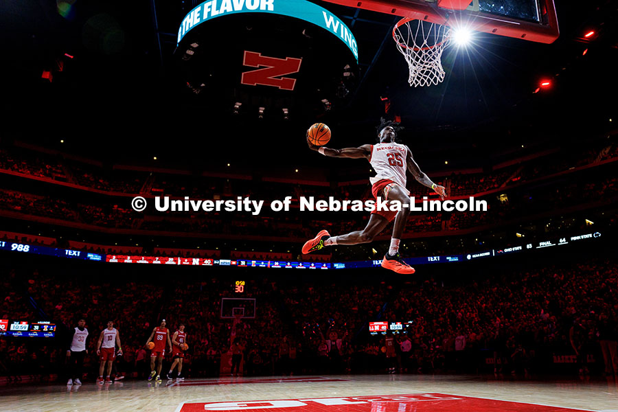 Nebraska football defensive back Jeremiah Charles defies gravity as he dunks the ball during the foo