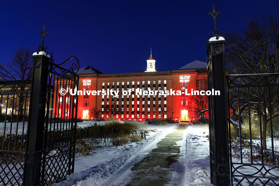 Love Library is lit up in red with gobos projected on the front saying, “Glow Big Red”. Glow Big