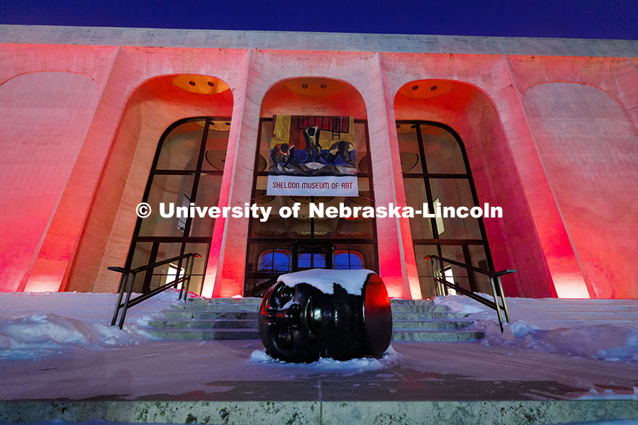 Snow covers the Fallen Dreamer sculpture and Sheldon Memorial Art Gallery’s steps as the front of 