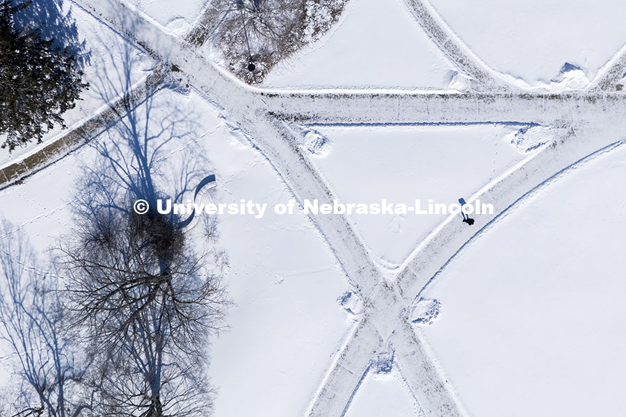 Aerial view of students crossing campus in the snow. Snow covered sidewalks. Snow on City Campus. Fe