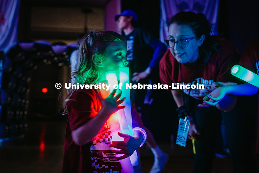 250301_Huskerthon_020.jpg Coralie, a miracle child, holds glow sticks during the Huskerthon rave. Huskerthon 2025, also known