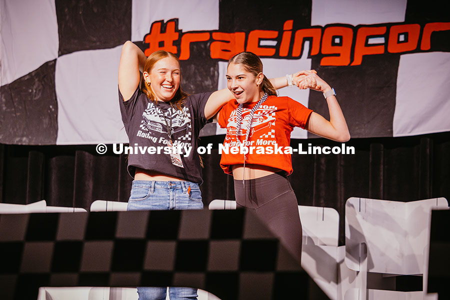 Avery (right), a miracle child and a member of her “Pit Crew” do a dance on the stage during the
