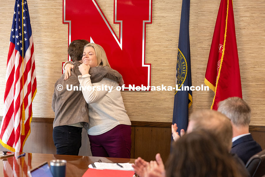 Jessie Herrmann, director of government relations, gives UNL senior Luke McDermott a congratulatory 