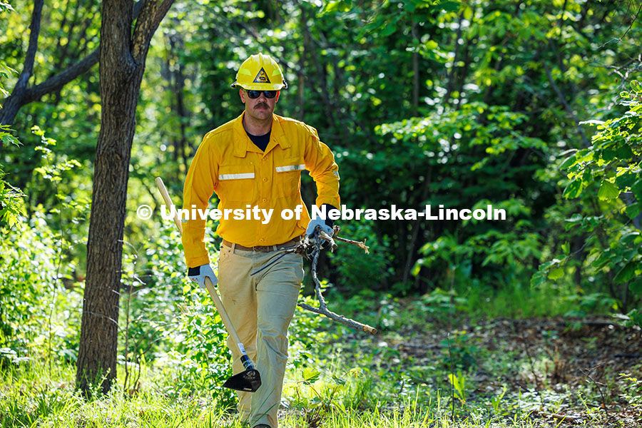 250507_Red Card Training_180.jpg Sam Morrow, a senior Grassland Systems major, carries sticks over to cover the fireline the class cr
