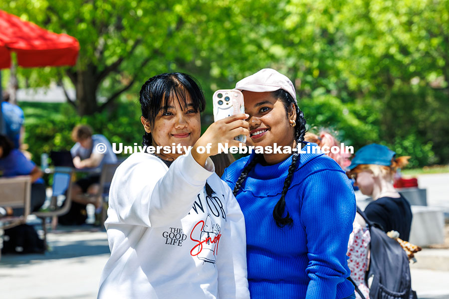250509_Big_Red_Finale_104.jpg Graduate students (left) Anisha Khandokar and Bhavana Sreekumar take a selfie after getting their ha
