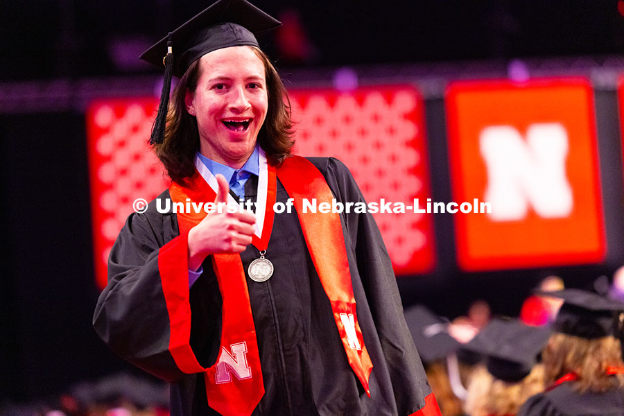 250517_Commencement_2247.jpg Computer Science major McKellan Clarke gives a thumbs up after receiving his diploma at the Universi