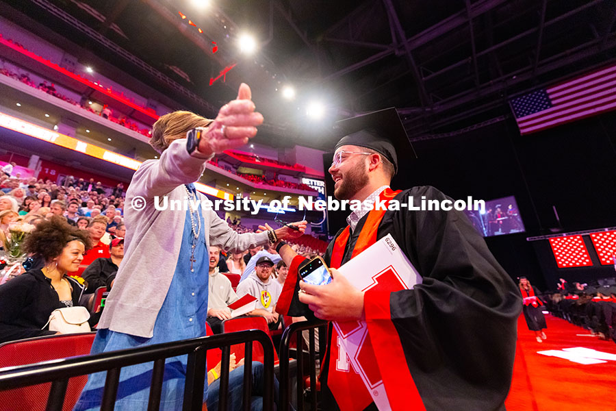 250517_Commencement_8065.jpg Business Administration graduate Jarrett Michie hugs his mother, Kim Michie, after receiving his dip