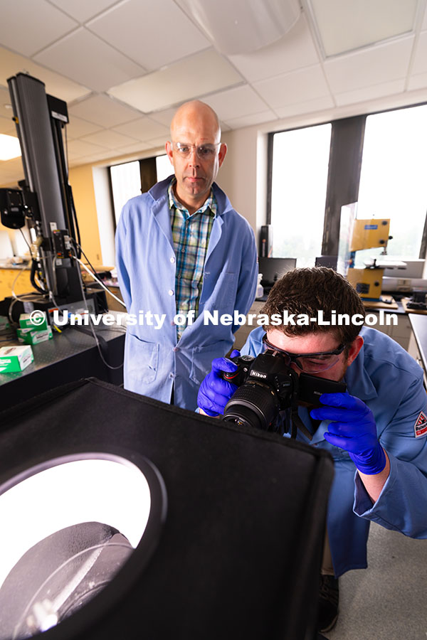250604_Morin_Watts_9493.jpg Doctoral student Brennan Watts points a camera at a small light box he and Stephen Morin, Associate