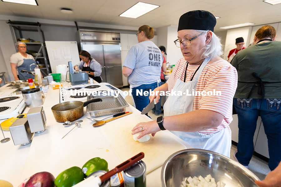 250604_Training_Academy_9518.jpg Elaine Rouse, kitchen manager for St. Margaret Mary School in Omaha, dices an onion that will be use