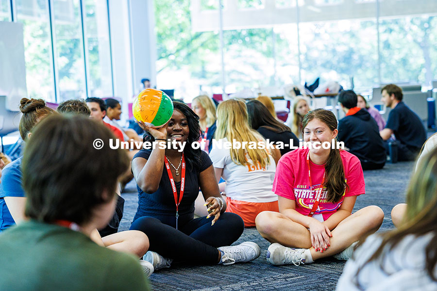 250610_NSE_199.jpg An incoming Husker holds a numbered beach ball during the Husker Power presentation in Love Library