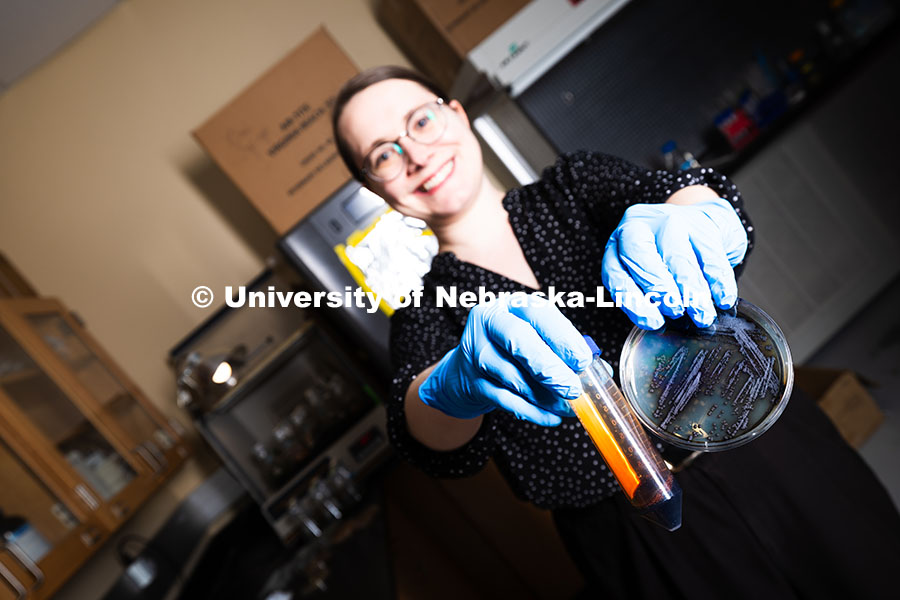 250618_Erin_Carr_540.jpg Erin Carr, a postdoctoral research associate, holds up a petri dish filled with streaky, spotty blac
