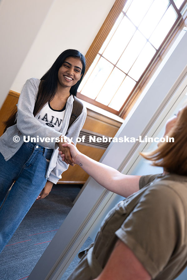 Laura Britten, Academic Navigator in the Explore Center, shakes hands with Swati Yadav, a sophomore 