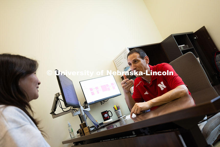 250624_Navigators_1282.jpg Parker Reed speaks with Mireu Ryu, a senior studying computer science, in his office in Hawks Hall.
