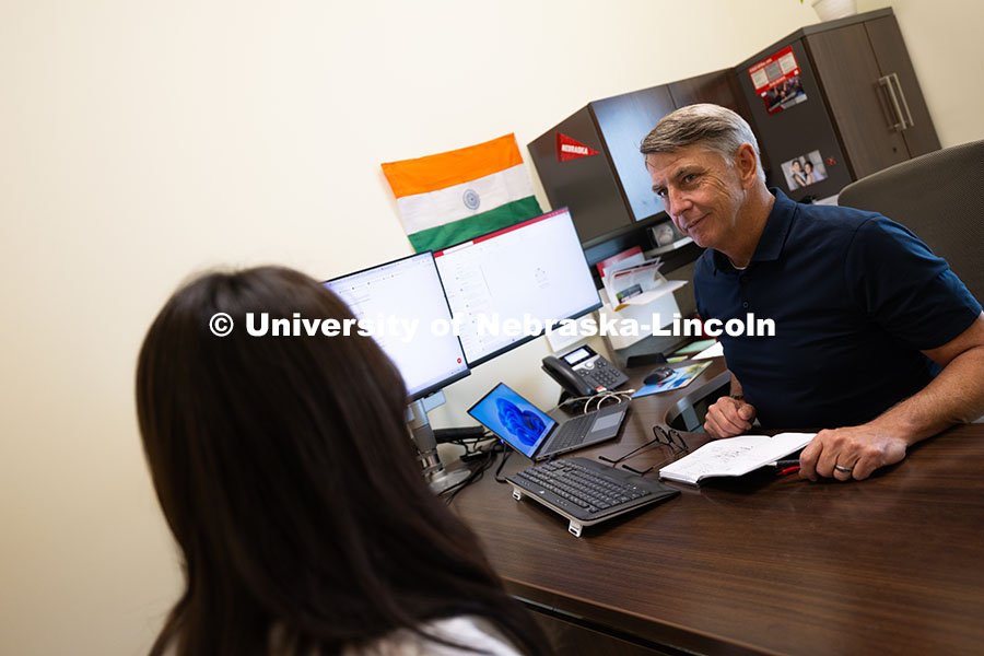 Dave Nebel speaks with Mireu Ryu, a senior studying computer science, in his office in Hawks Hall. N