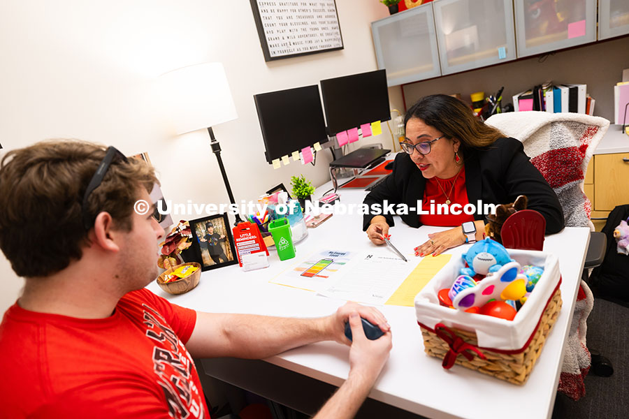 Mari Beck talks with Jacob Behnk, a senior studying Spanish and global studies, in her office in the