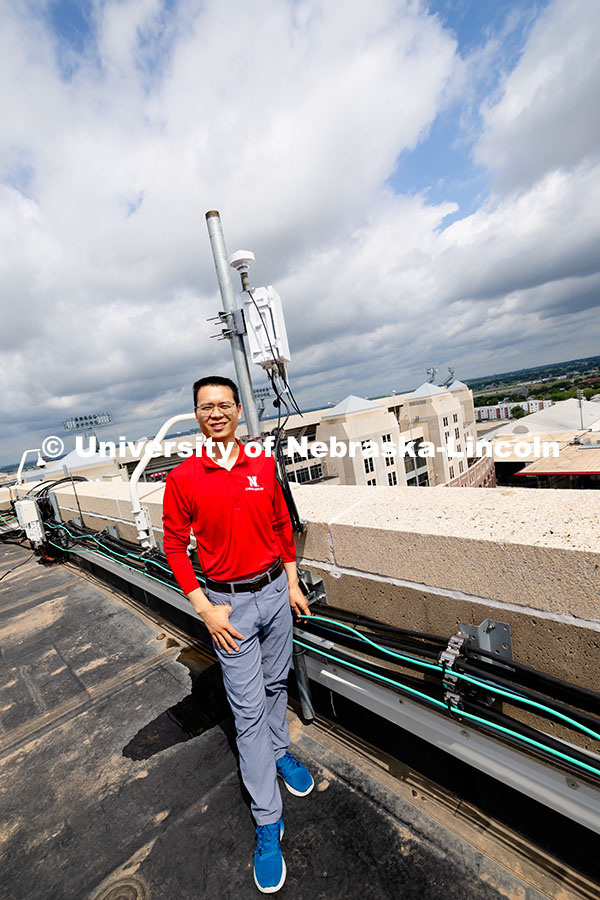 250626_Qiang_Liu_1976.jpg Qiang Liu, assistant professor in the School of Computing, stands next to one of the Husker-Net 5G a