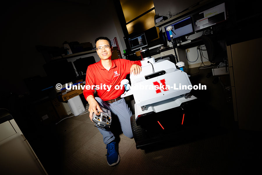 250626_Qiang_Liu_1996.jpg Qiang Liu, assistant professor in the School of Computing, poses next to a small vehicle used by the