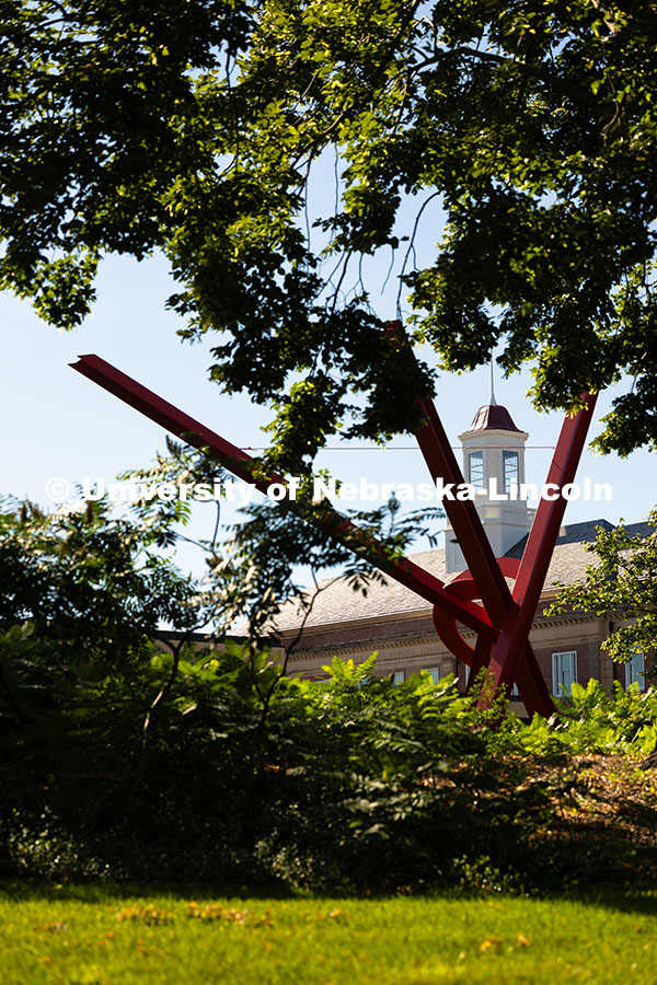 250709_City_Campus_2506.jpg The beams of Old Glory, a sculpture by Mark Di Suvero, frame the cupola of Love Library on a warm, J