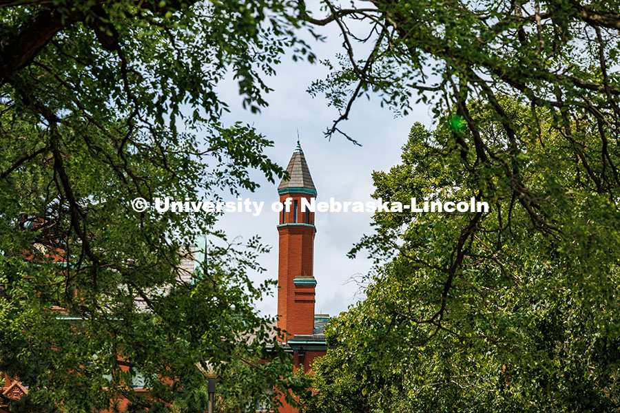 Architecture Hall's turret is framed by trees. Summer on City Campus. July 16, 2025. 