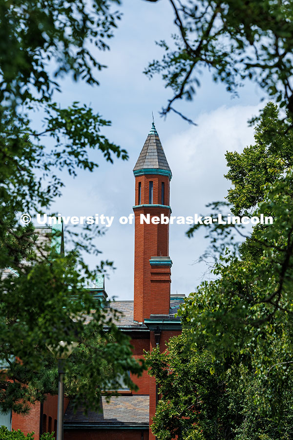 250716_City_Campus_132.jpg Architecture Hall's turret is framed by trees. Summer on City Campus. July 16, 2025.