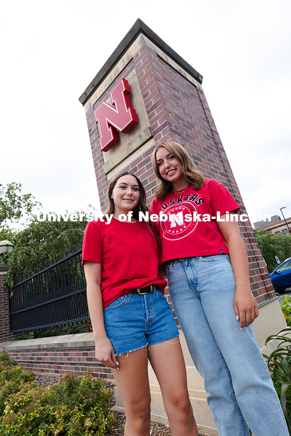 250716_PSA_Haring_3061.jpg Sisters Madison and Lauren Haring pose next to a Husker "N" on the entrance gates by the Nebraska Un