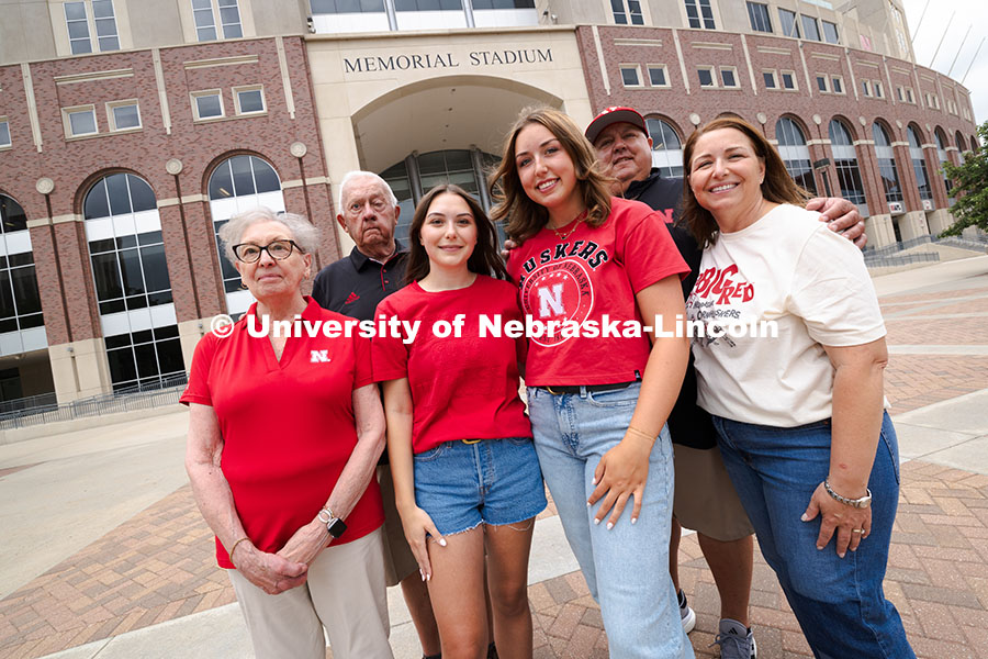 Sisters Madison and Lauren Haring pose with their family outside of Memorial Stadium. The Haring fam