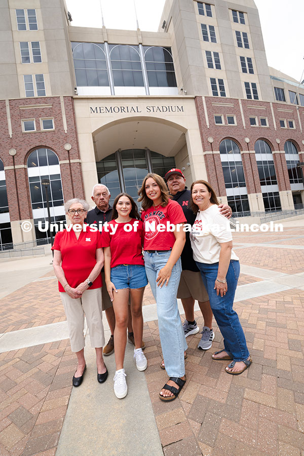 250716_PSA_Haring_3099.jpg Sisters Madison and Lauren Haring pose with their family outside of Memorial Stadium. The Haring fam