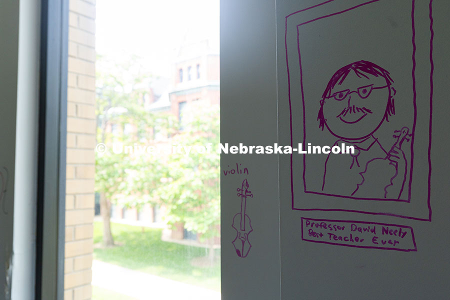 A student rendering of David Neely, Professor of Violin, drawn on the wall of his office in the old 
