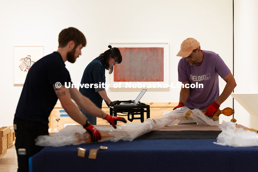 Natalie Yates, Associate Registrar for Collections and Exhibitions, checks a diagram of Niho Kozuru'