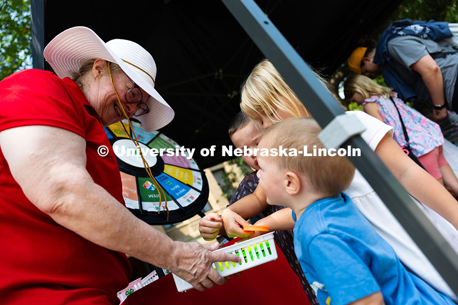Saundra Frerichs holds a basket of mini frisbees to Graham, Margot and Everett Schroeckenthaler at t