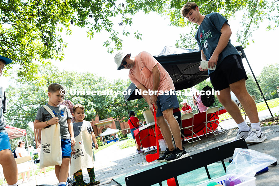 250810_Discovery_Days_3480.jpg Jim Kolbo uses a plastic putter to aim for the target in a probability game at the 4-H booth during
