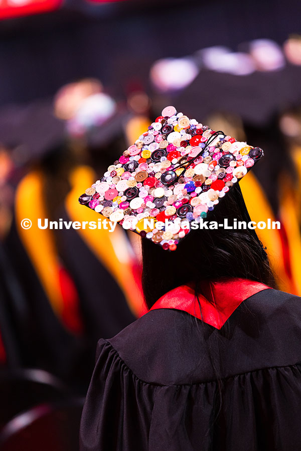 250816_Commencement_3540.jpg As a fashion design major, Denali Ingram used a bunch of colorful buttons to decorate her cap. Summe