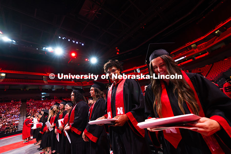 250816_Commencement_3693.jpg Graduates grin after receiving their diplomas. Summer Commencement ceremony in Pinnacle Bank Arena.