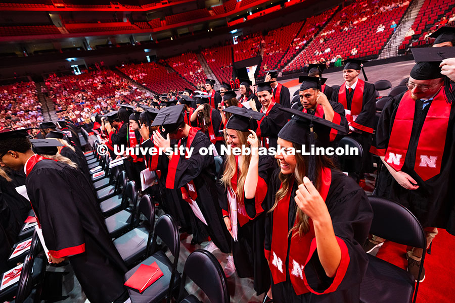 Graduates turn their tassels after receiving their undergraduate degrees at the summer commencement.