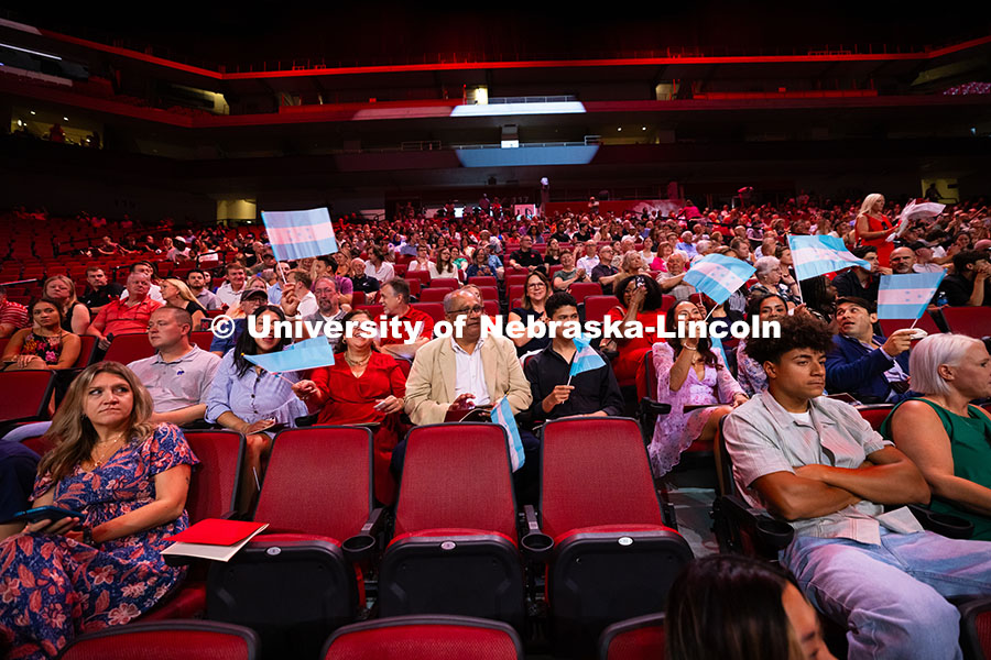 Family members wave Honduran flags to the beat of "There is No Place Like Nebraska" as the recession