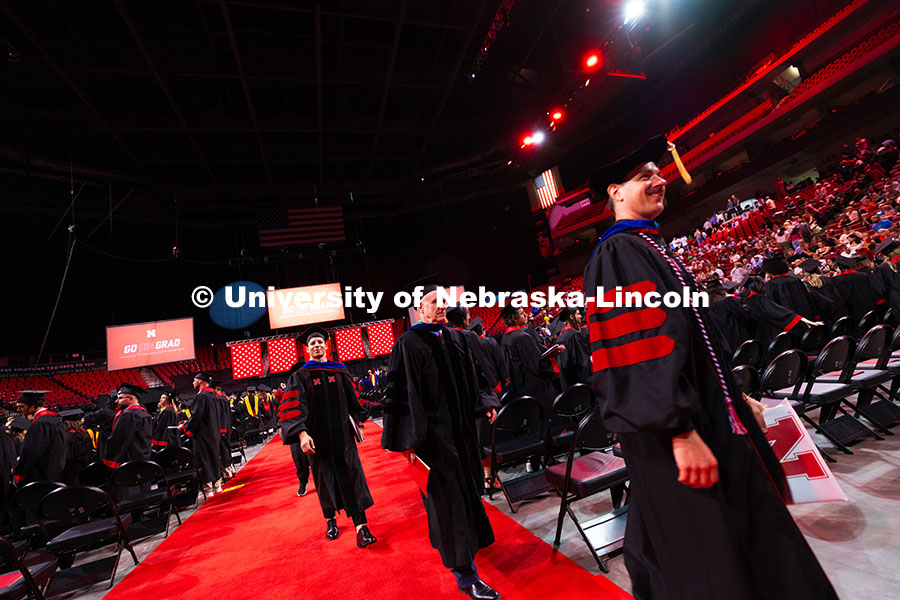 Wajdi Belgacem follows his adviser, Professor Jay Parsons, out of Pinnacle Bank Arena after receivin