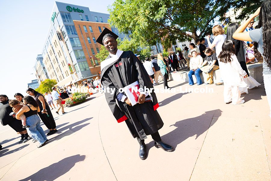 250816_Commencement_3765.jpg Oluseye Fakinlede poses for a photo in the Haymarket after the summer commencement ceremony. Summer