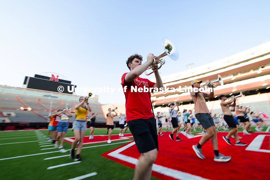 250818 Band Camp 3887.jpg Eli Schuster, a senior mellophone player, marches during a warm-up exercise during rehearsal on the