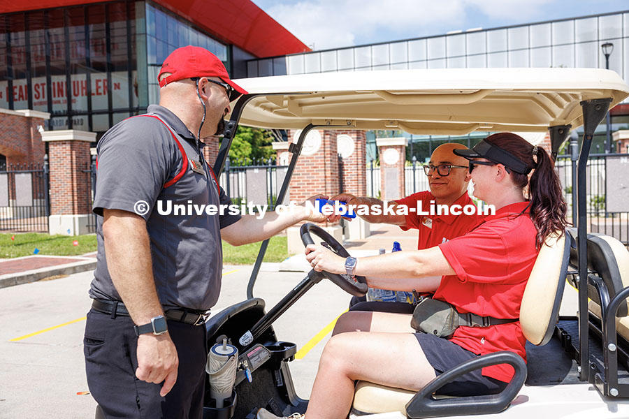 T.J. McDowell, Assistant Vice Chancellor/Dean of Students, hands Tony Lazarowicz, volunteer and Dire