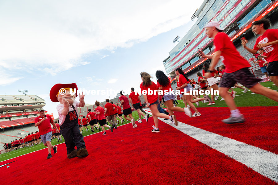 250822_Tunnel_Walk_4176.jpg Students run onto the field in Memorial Stadium for the Tunnel Walk. Tunnel Walk into Memorial Stadi
