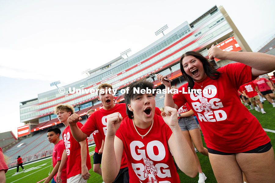 Students cheer after running into Memorial Stadium during the Tunnel Walk, before lining up to form 