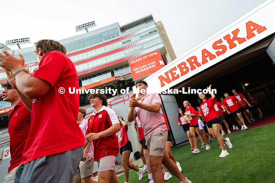 250822_Tunnel_Walk_4195.jpg Students run onto the field in Memorial Stadium for the tunnel walk. Tunnel Walk into Memorial Stadi