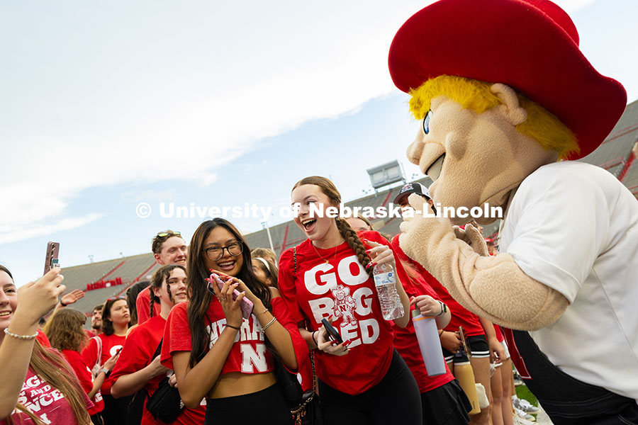 250822_Tunnel_Walk_4239.jpg Students take selfies with Herbie Husker in Memorial Stadium after the tunnel walk. Tunnel Walk into