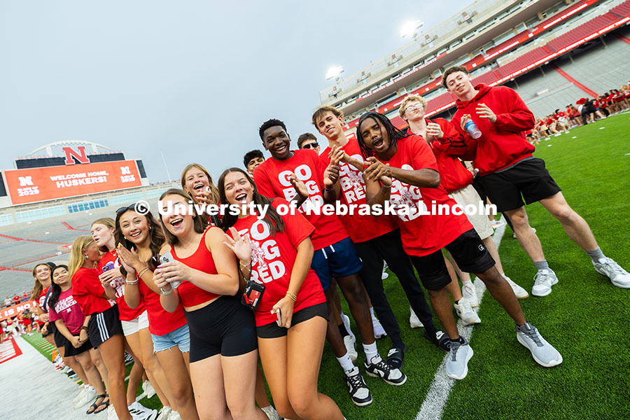 Students cheer in Memorial Stadium as they form an “N” on the Memorial Stadium field for the cla