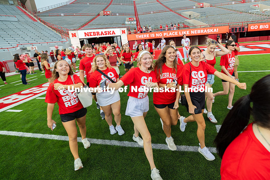 Students cheer after running onto the field in Memorial Stadium during the Tunnel Walk, before linin